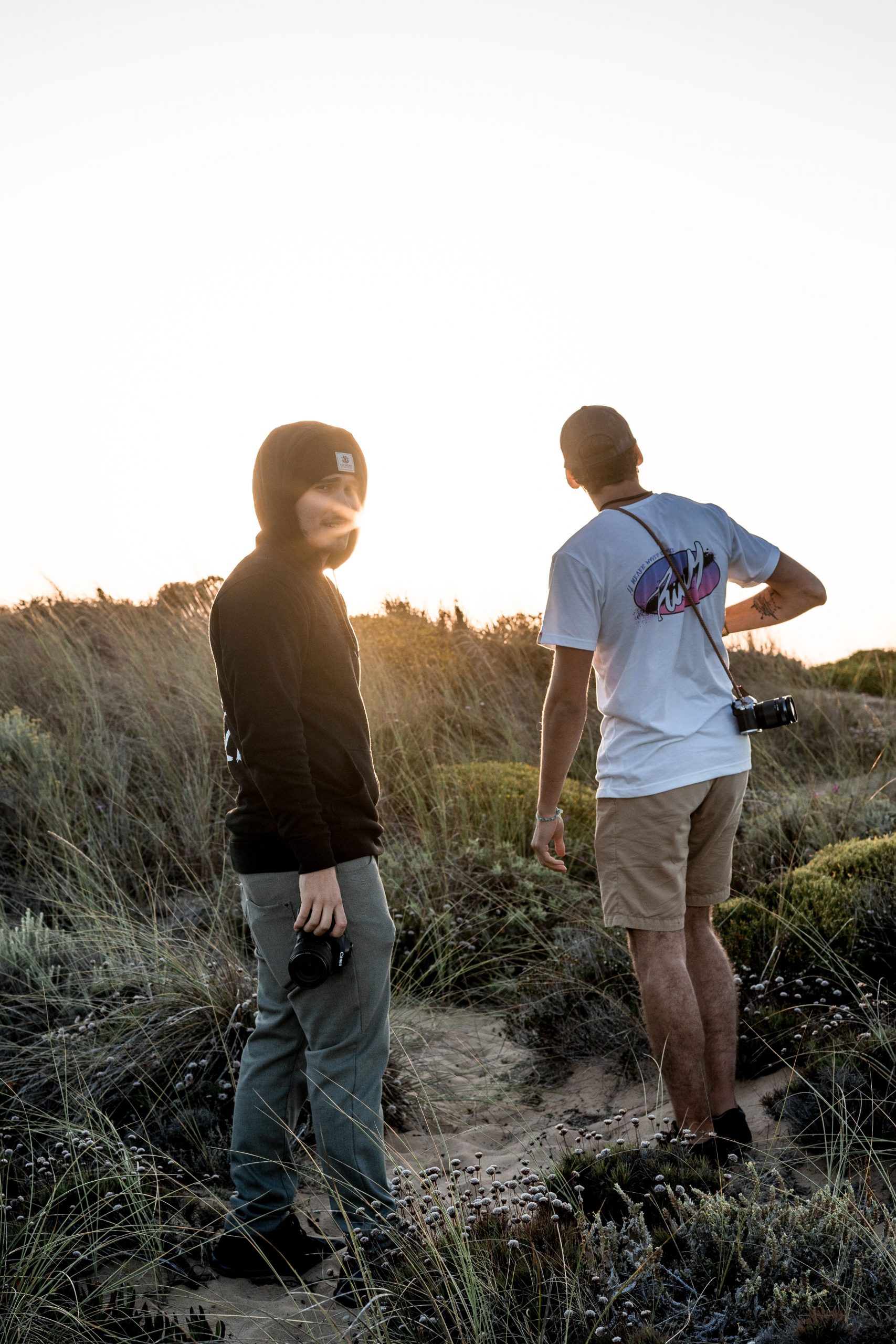Two men standing in the dunes