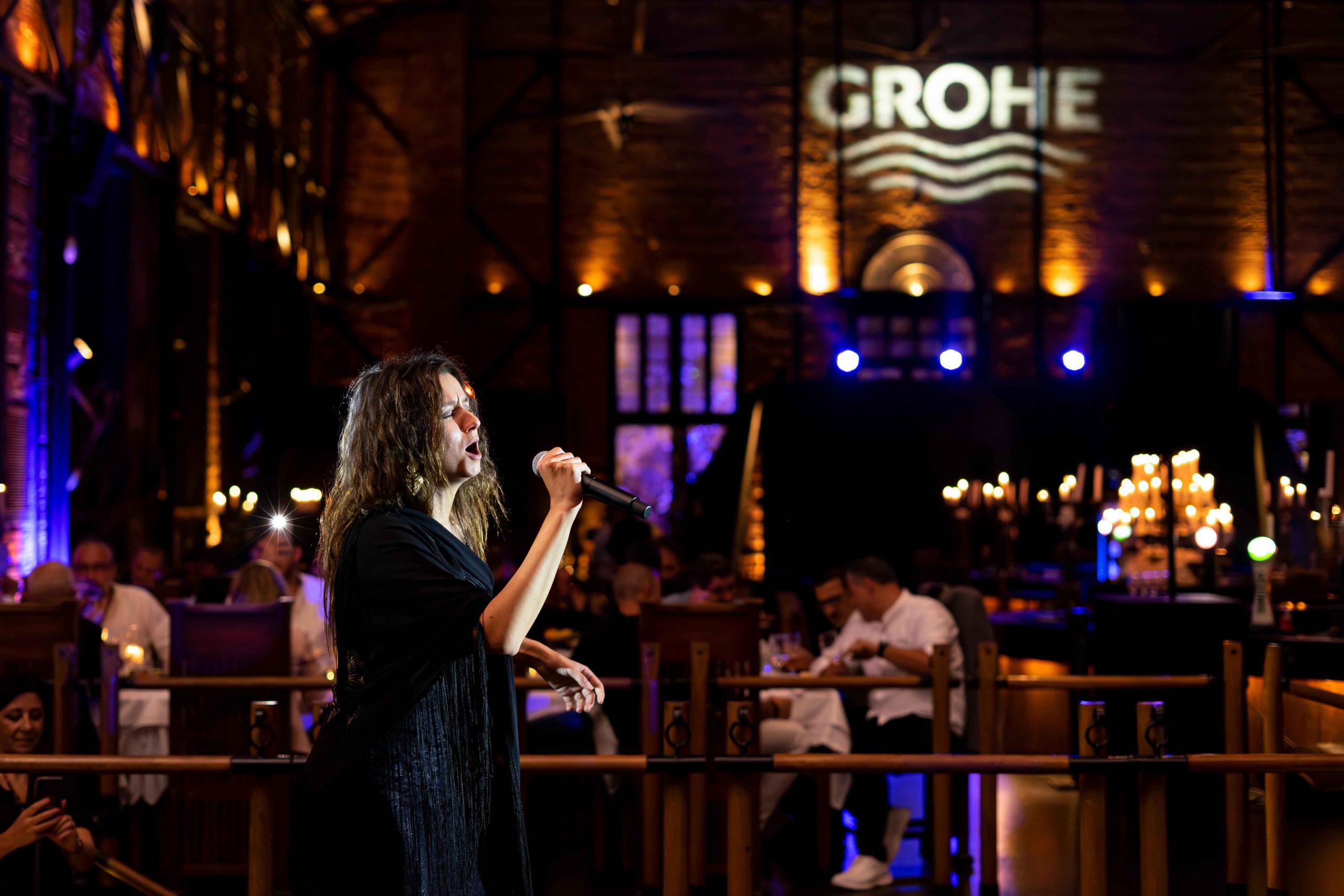 Singer performing and people dining